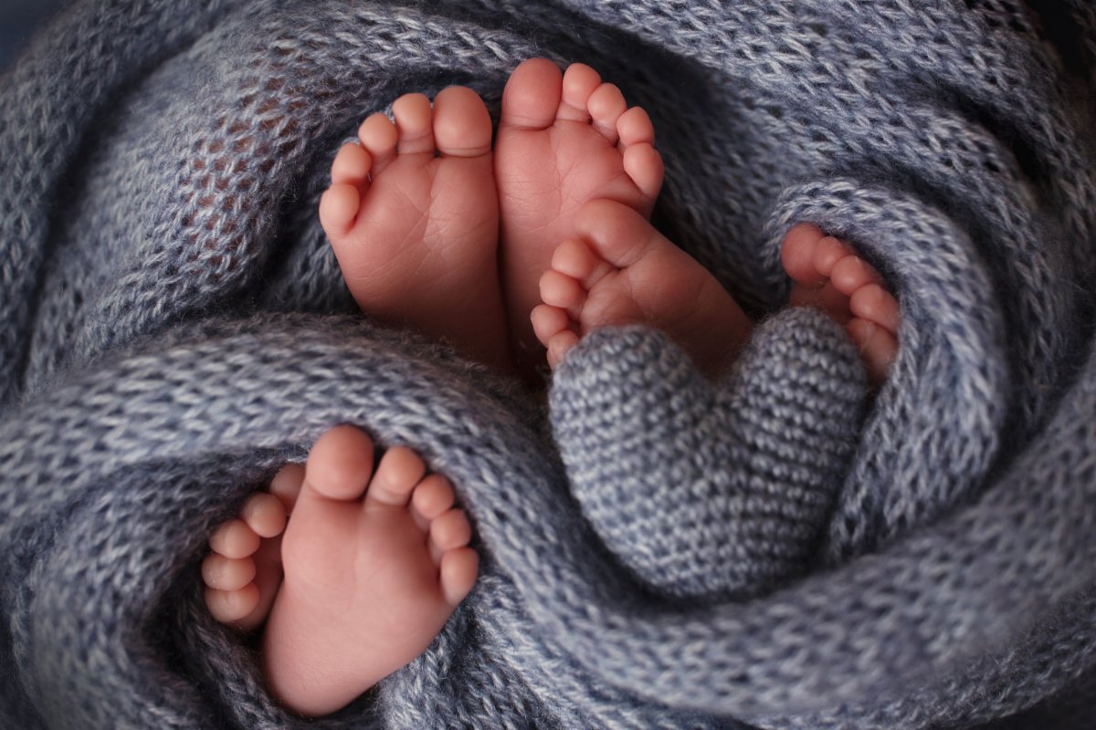 Three pairs of babies' feet